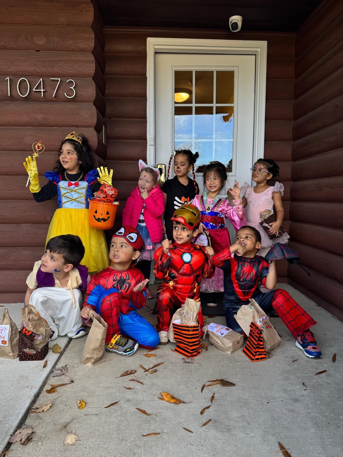Children in Halloween costumes celebrating outside the school
