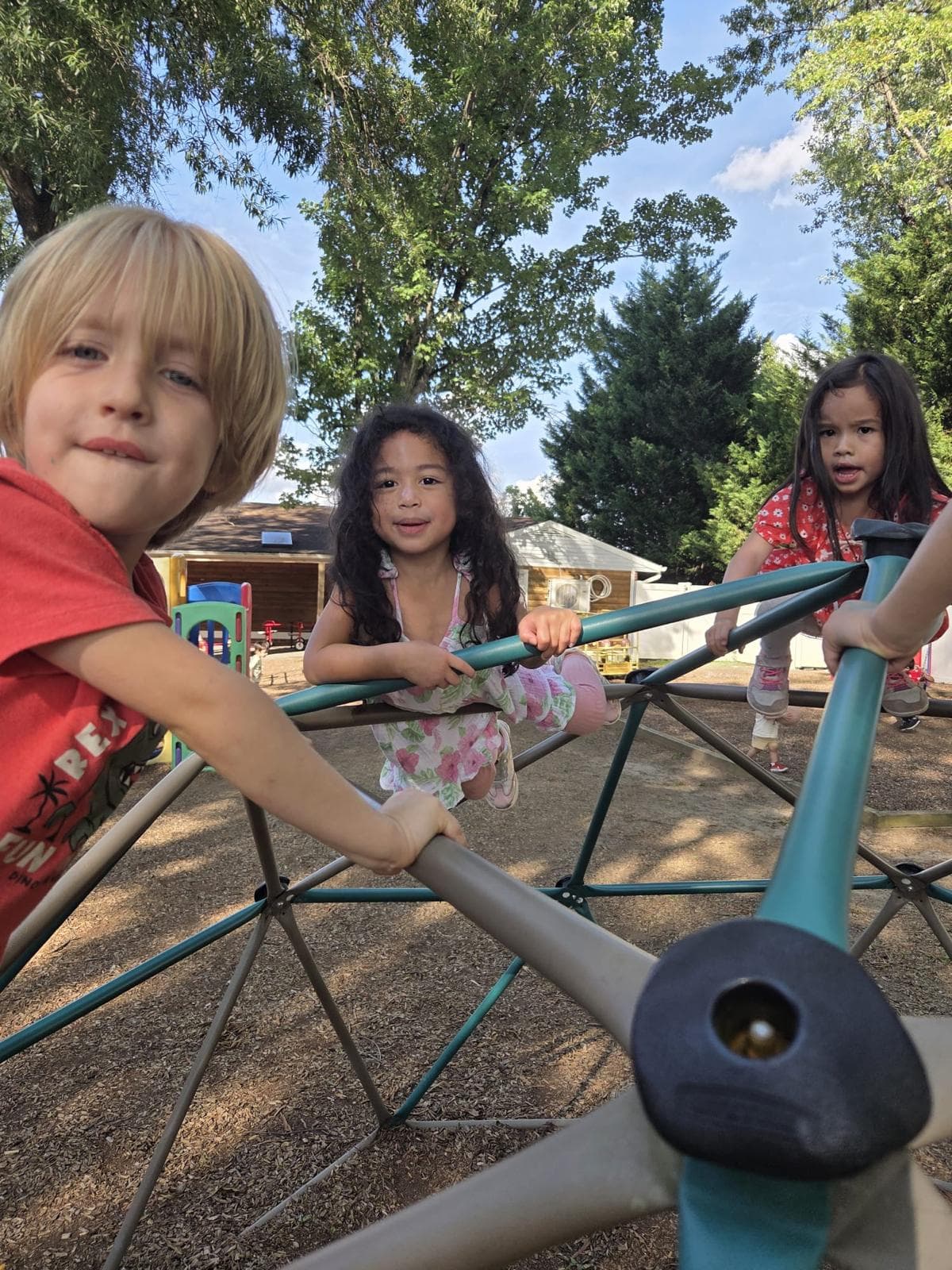 Children climbing the dome on the Good Beginnings playground