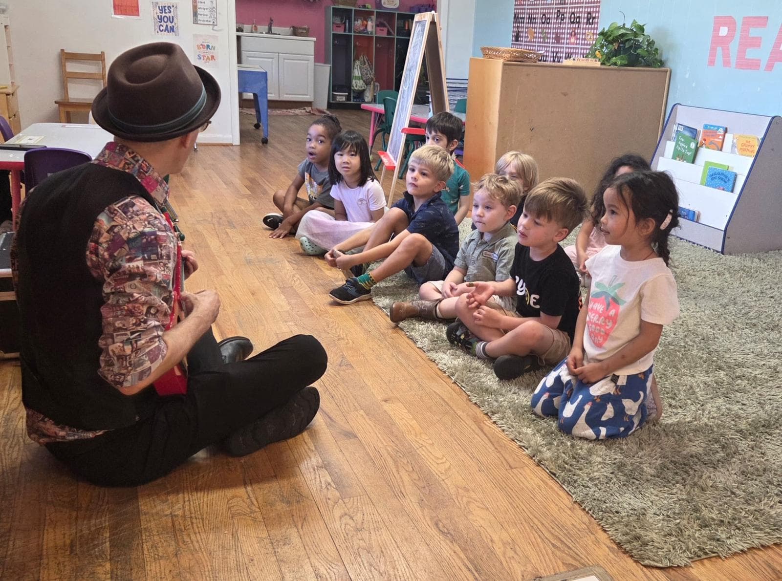 Children listening to a visiting musician in the classroom